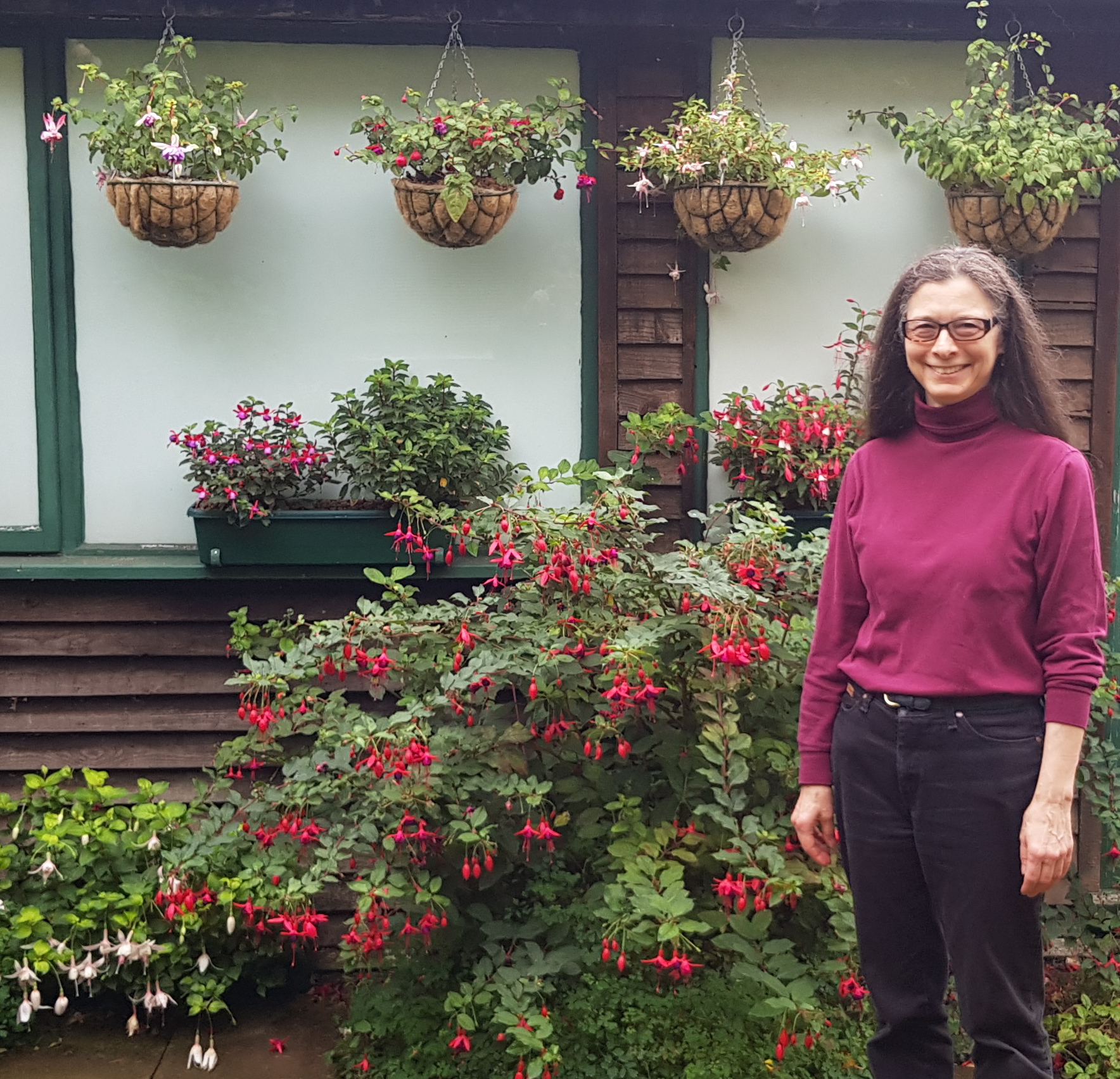 Isabella in front of our fuchsias